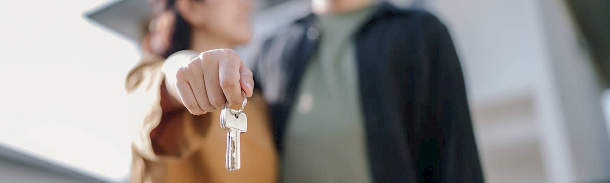 Young family getting keys to new home