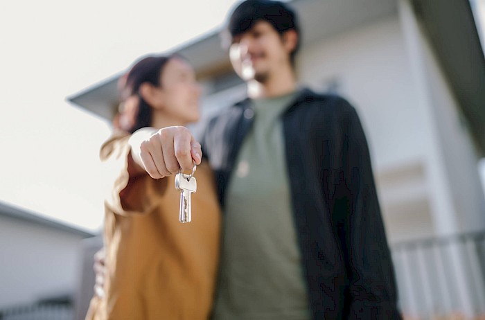 Young family getting keys to new home